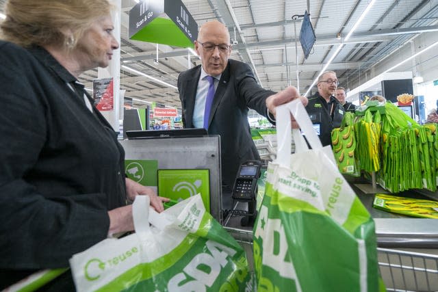 Scottish First Minister John Swinney helping out on the check-out at Asda Chesser Supermarket, in Edinburgh