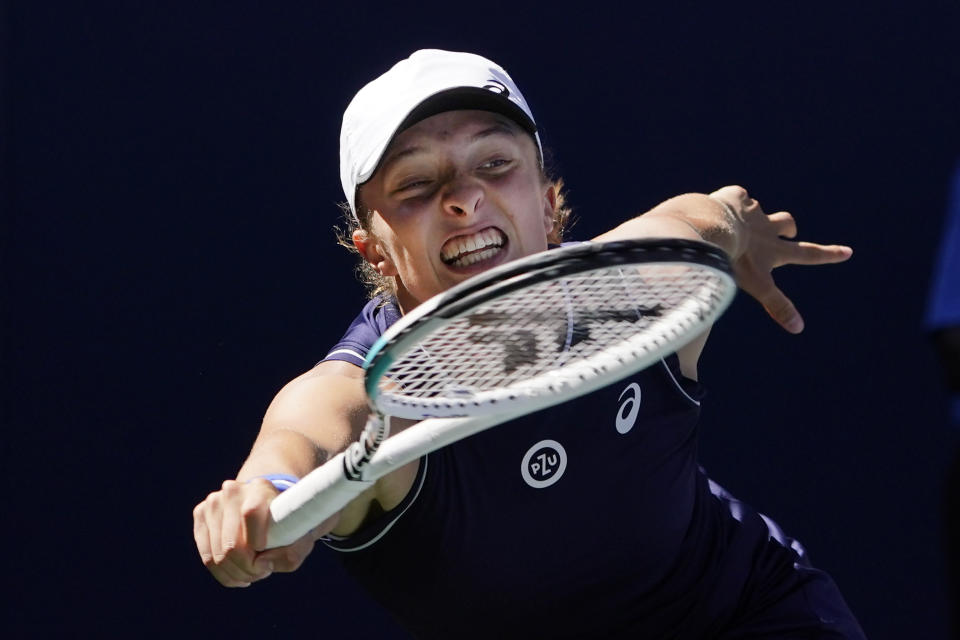 FILE -Iga Swiatek, of Poland, reaches for a return against Belinda Bencic, of Switzerland, during the fourth round of the U.S. Open tennis championships, Monday, Sept. 6, 2021, in New York. French Open champion and top-ranked Iga Swiatek enters Wimbledon on a 35-match winning streak. (AP Photo/Elise Amendola, File)