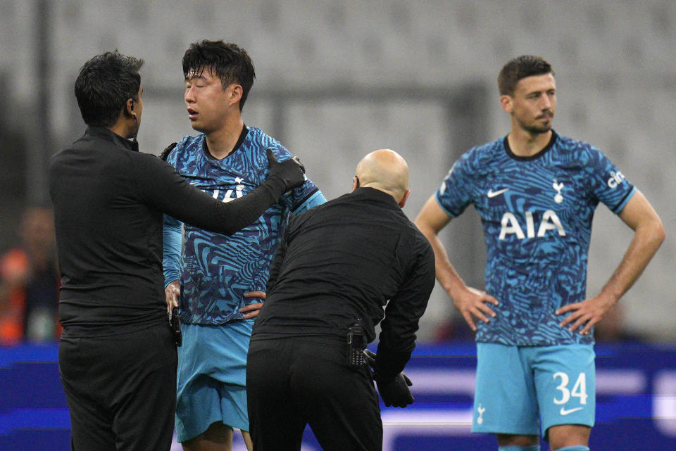 Tottenham's Son Heung-min receives treatment after taking a knock during the Champions League Group D soccer match between Marseille and Tottenham Hotspur at the Stade Velodrome in Marseille, France, Tuesday, Nov. 1, 2022. When Son Heung-min went down clutching his face in Tottenham’s Champions League match with Marseille last week the pain was not confined to his fractured eye socket. The shockwaves were felt all the way back in his homeland South Korea as the nation feared the worst ahead of the World Cup. (AP Photo/Daniel Cole)