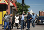 Minnesota Gov. Tim Walz, center, takes a walking tour of some of the artworks commissioned by Springboard for the Arts along University Avenue in St. Paul, Minn., Monday, June 8, 2020. (Glen Stubbe/Star Tribune via AP, Pool)