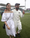 India's cricket captain Virhat Kohli, right, walks with his wife, Anushka Sharma celebrates India's series win over Australia after play was called off on day 5 of their cricket test match in Sydney, Monday, Jan. 7, 2019. The match is a draw and India wins the series 2-1.(AP Photo/Rick Rycroft)