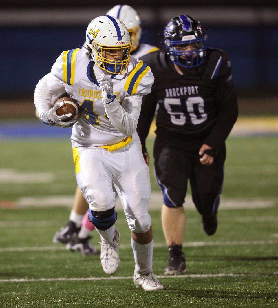 Irondequoit tight end Isaiah Ballard looks for extra yards ahead of Brockport defender Dylan Lessar. 