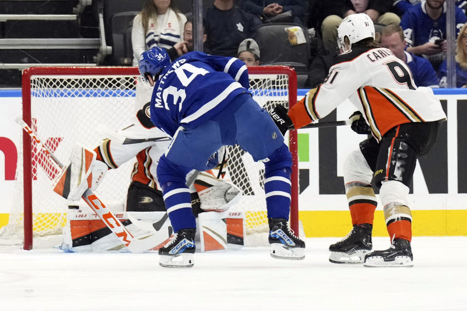 Toronto Maple Leafs' Auston Matthews (34) scores against Anaheim Ducks goaltender Lukas Dostal during the first period of an NHL hockey game, Saturday, Feb. 17, 2024 in Toronto. (Chris Young/The Canadian Press via AP)