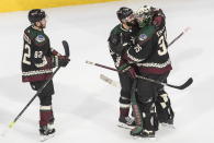 Arizona Coyotes' Jordan Oesterle (82), Alex Goligoski (33) and goalie Darcy Kuemper (35) celebrate the win over the Colorado Avalanche in an NHL hockey Stanley Cup first-round playoff series, Saturday, Aug. 15, 2020, in Edmonton, Alberta. (Jason Franson/The Canadian Press via AP)