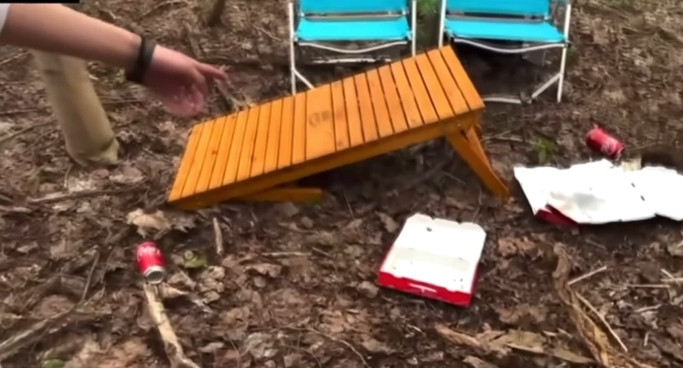 A screenshot shows the collapsed table and pizza boxes on the ground.