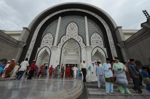 Muslims are seen leaving a mosque in Kuala Lumpur. Malaysia on Sunday deported a young Saudi journalist who is wanted in his home country over a Twitter post about the Prophet Mohammed that sparked calls for his execution, according to an official