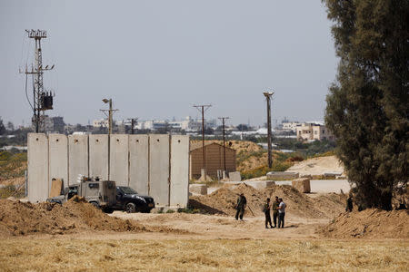 Israeli soldiers stand close to a security barrier near the border between Israel and the Gaza Strip, Israel March 18, 2018. REUTERS/Amir Cohen