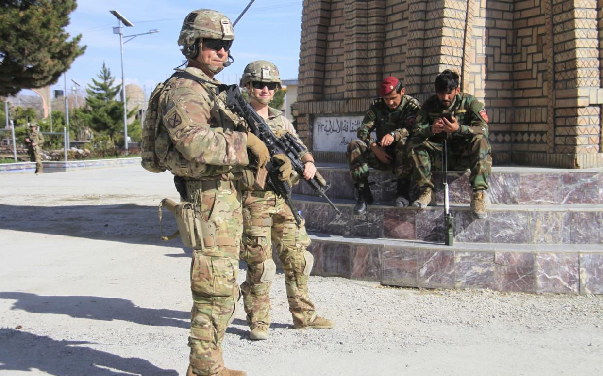 US soldiers stand guard during a Nato meeting in Afghanistan - REX