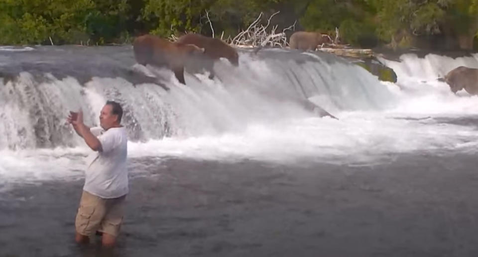 Three men went off the path at a national park in Alaska and into the water where bears were feeding. Source: Youtube