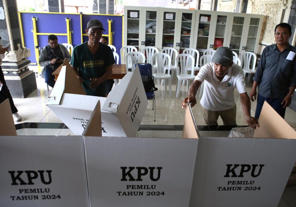 Men prepare a polling station in Denpasar, Bali, Indonesia (AP)