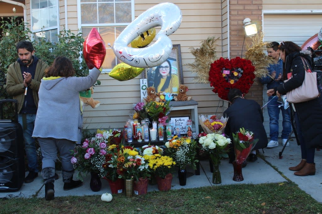 Friends and family of Gaby Ramos place floral bouquets and balloons at a makeshift altar outside the slain radio personality’s home on Tuesday, 19 October. (Enrique Limón)