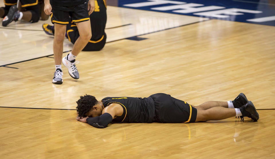 Appalachian State guard Justin Forrest (1) lies on the floor after his team's loss to Norfolk State in a First Four game in the NCAA men's college basketball tournament, Thursday, March 18, 2021, in Bloomington, Ind. (AP Photo/Doug McSchooler)
