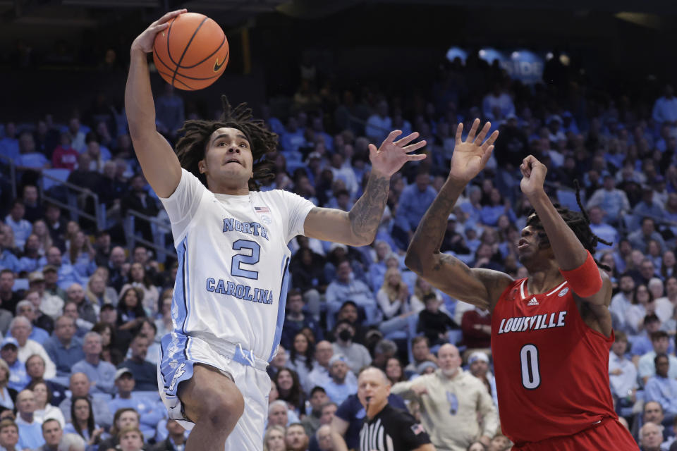 North Carolina guard Elliot Cadeau (2) drives to the basket against Louisville guard Mike James (0) during the first half of an NCAA college basketball game Wednesday, Jan. 17, 2024, in Chapel Hill, N.C. (AP Photo/Chris Seward)