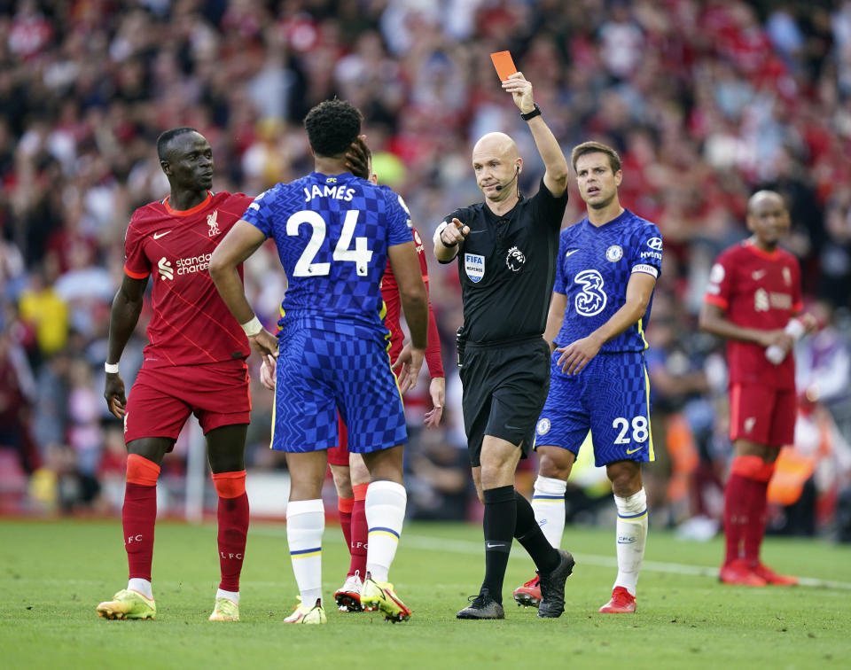 Chelsea's Reece James is shown a red card by referee Anthony Taylor during the English Premier League soccer match between Liverpool and Chelsea at Anfield, Liverpool, England, Saturday, Aug. 28, 2021. (Mike Egerton/PA via AP)