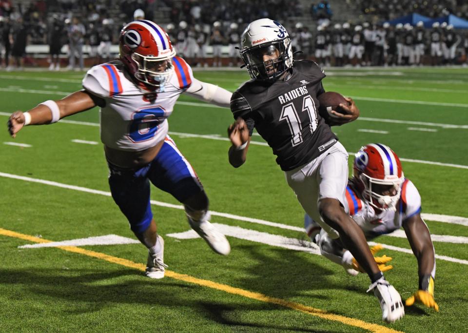 Huntington's Landon Gibbs tries to slip past Evagnel's Damari Drake during Friday's game at Independence Stadium.