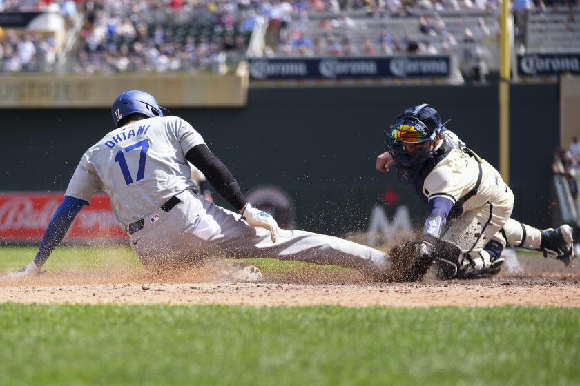 Los Angeles Dodgers designated hitter Shohei Ohtani (17) is tagged out at home plate by Minnesota Twins catcher Christian Vázquez to end the top of the seventh inning of a baseball game Wednesday, April 10, 2024, in Minneapolis. (AP Photo/Abbie Parr)