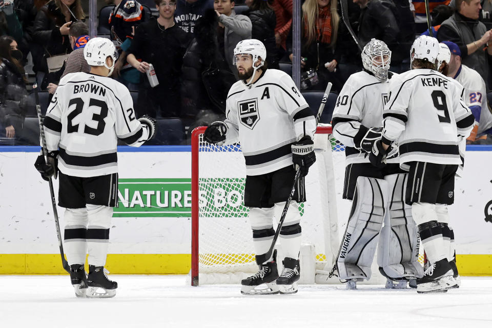 Los Angeles Kings defenseman Drew Doughty (8) celebrates with Dustin Brown (23) after defeating the New York Islanders in an NHL hockey game Thursday, Jan. 27, 2022, in Elmont, N.Y. (AP Photo/Adam Hunger)