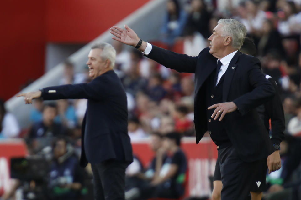 Mallorca's head coach Javier Aguirre, left and Real Madrid's head coach Carlo Ancelotti gesture during a Spanish La Liga soccer match between Mallorca and Real Madrid at the Son Moix stadium in Palma de Mallorca, Spain, Saturday, April 13, 2024. (AP Photo/Francisco Ubilla)