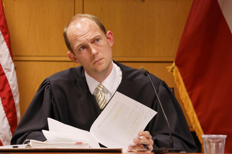 Fulton County Superior Court Judge Scott McAfee listens as motions are presented in his courtroom by Brian Rafferty, attorney for Sidney Powell, in Atlanta, Thursday, Oct. 5, 2023. Eighteen people, including former President Donald Trump, have been charged in a sweeping criminal conspiracy case to overturn the outcome of Georgia's 2020 presidential election results. (Erik S. Lesser/Pool Photo via AP)