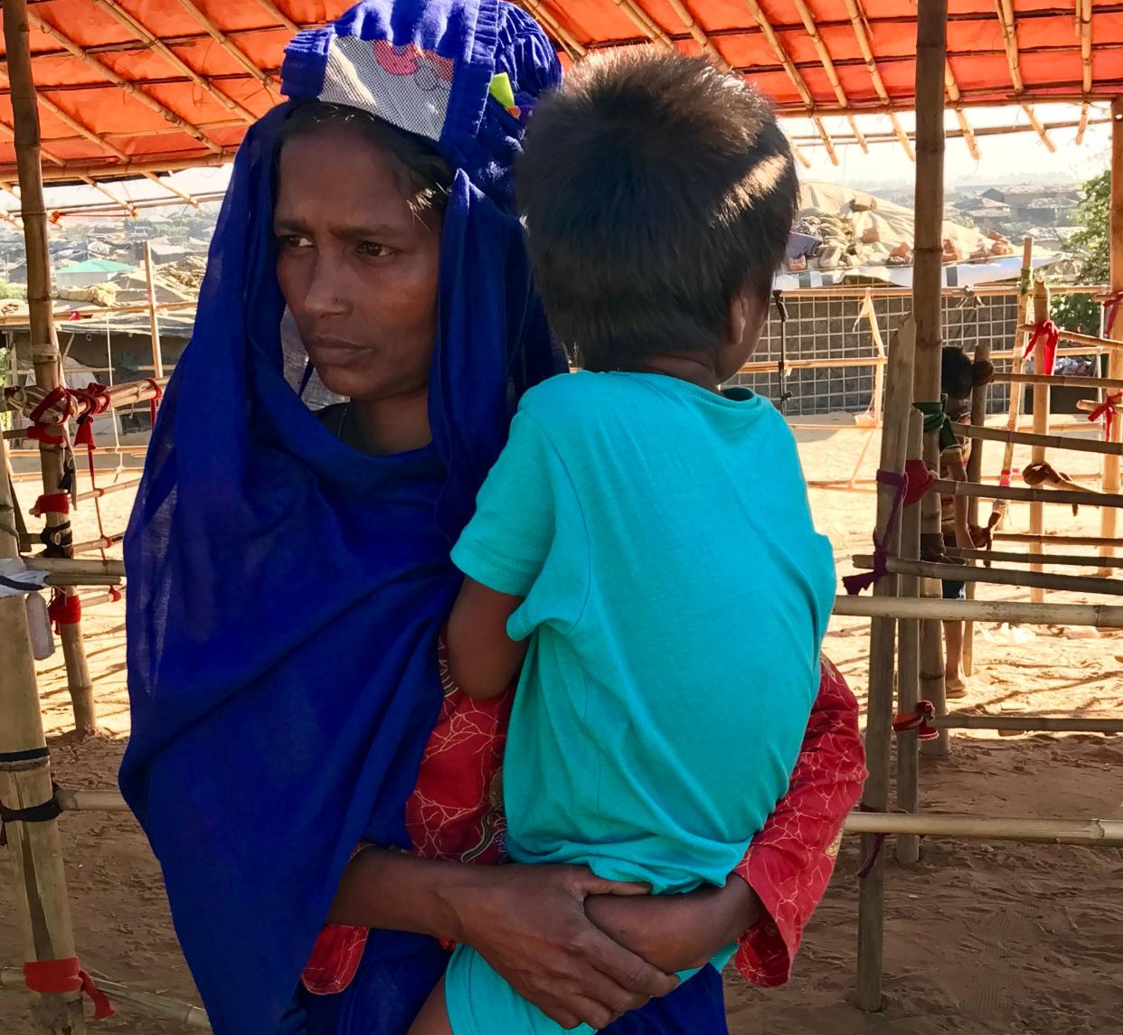 Hadara&nbsp;holds her child. (Photo: Rachael Heath Ferguson)