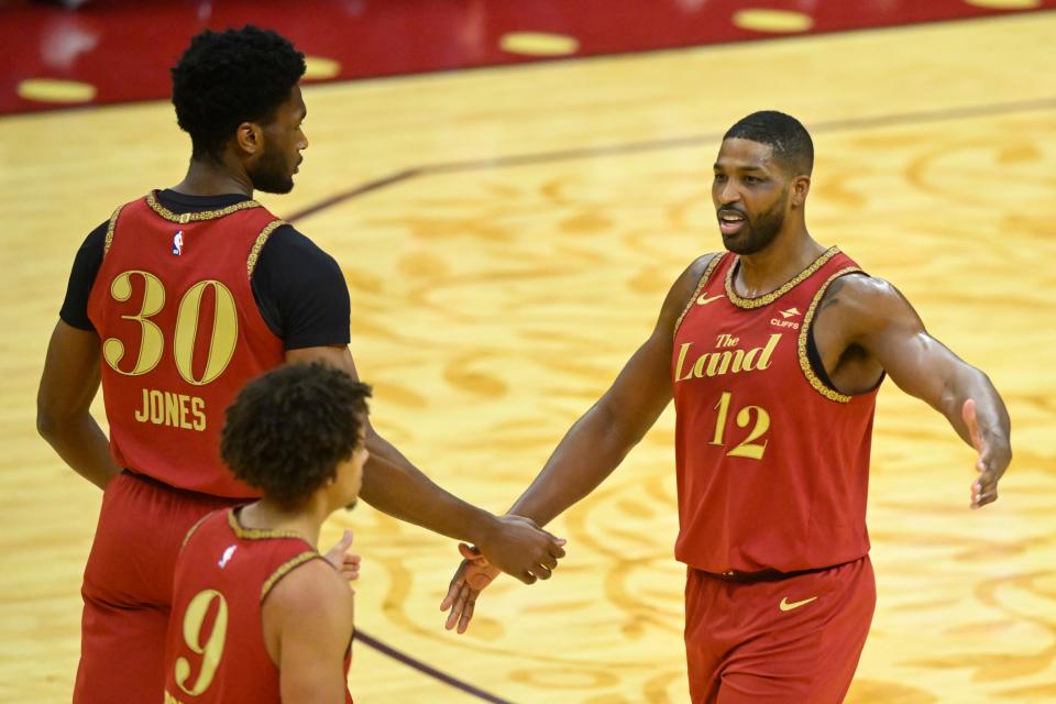Cleveland Cavaliers forward Tristan Thompson (12) celebrates with center Damian Jones (30) and guard Craig Porter (9) against the Washington Wizards on Jan. 3 in Cleveland.