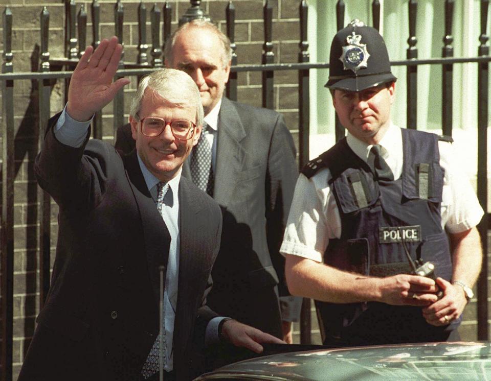 FILE - Britain's outgoing Prime Minister John Major waves as he leaves Downing Street, London, May 2, 1997, to tender his resignation to the Queen at Buckingham Palace. The upcoming general election on July 4, 2024, is widely expected to lead to a change of government for the first time in 14 years. In 1997, the Labour Party had been out of power for longer than it has been now - 18 years - and it was quite a turnaround when Labour, under the leadership of the youthful Tony Blair, won the May 1, 1997 general election by a landslide majority of 179 seats. (AP Photo/Dave Caulkin, File)