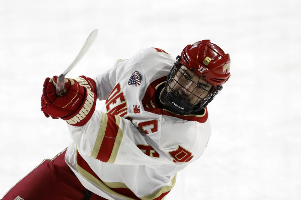 FILE - Denver forward McKade Webster (6) shoots before the start of an NCAA hockey game against Massachusetts on Thursday, March 28, 2024, in Springfield, Mass. Denver Pioneers forward McKade Webster will try to follow his younger sister’s lead after Makenna helped Ohio State win an NCAA hockey championship last month. McKade and the Pioneers face Boston University in a Frozen Four semifinal game, with the winner advancing to the title game. (AP Photo/Greg M. Cooper, File)