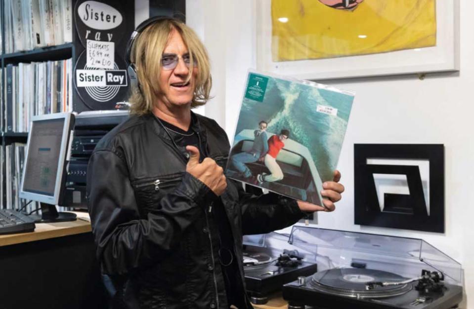 Joe Elliott holding a copy of Sparks' Propaganda album