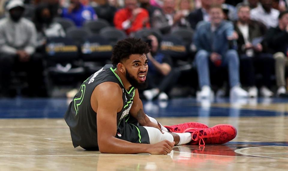 WASHINGTON, DC - NOVEMBER 28: Karl-Anthony Towns #32 of the Minnesota Timberwolves reacts after being injured in the third quarter against the Washington Wizards at Capital One Arena on November 28, 2022 in Washington, DC. NOTE TO USER: User expressly acknowledges and agrees that, by downloading and or using this photograph, User is consenting to the terms and conditions of the Getty Images License Agreement. (Photo by Rob Carr/Getty Images)