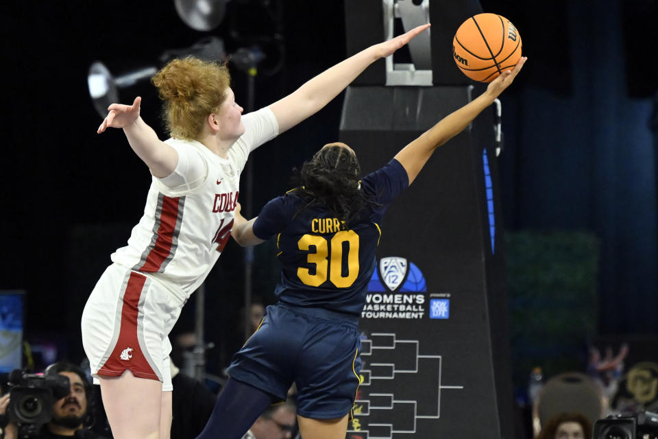 Washington State center Jessica Clarke, left, attempts a block against California guard Jayda Curry (30) during the second half of an NCAA college basketball game in the first round of the Pac-12 women's tournament Wednesday, March 1, 2023, in Las Vegas. (AP Photo/David Becker)