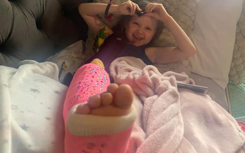 Millie at home with a cast on. See SWNS story SWLNdrama. A five-year-old girl was left screaming in pain with a broken leg after she was dubbed a 