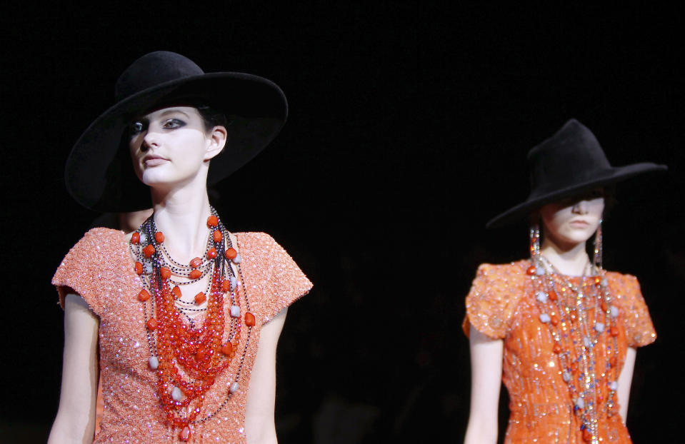 Models wear creations part of the Giorgio Armani Women's Fall-Winter 2012-13 fashion collection, during the fashion week in Milan, Italy, Monday, Feb. 27, 2012. (AP Photo/Antonio Calanni)