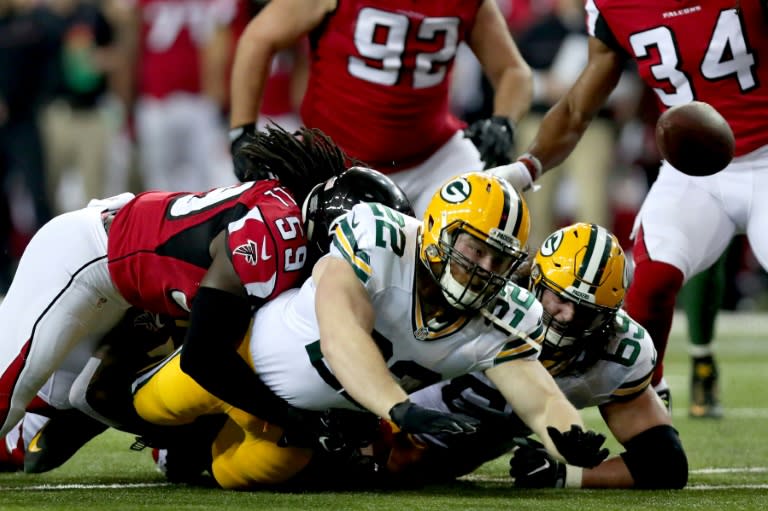 Aaron Ripkowski of the Green Bay Packers fumbles as he is tackled by De'Vondre Campbell of the Atlanta Falcons in the second quarter in the NFC Championship Game at the Georgia Dome on January 22, 2017 in Atlanta, Georgia