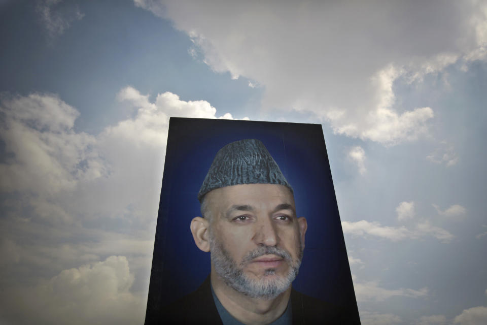 In this Saturday, March 29, 2014 photo, a giant picture of Afghan President Hamid Karzai is displayed on the parade ground of the Ministry of Defense in Kabul, Afghanistan. Karzai inherited a broken country when the Americans and their allies chose him more than 12 years ago as a leader they hoped could cross ethnic lines, embrace former enemies and bring Afghans together. As he prepares to leave office, Afghanistan has made great strides yet remains hobbled by a resilient Taliban insurgency and fears of a return to civil war. (AP Photo/Anja Niedringhaus)