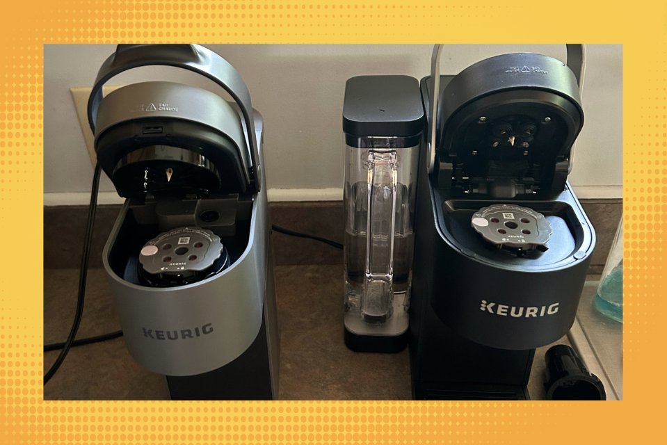 Two Keurig machines (one gray, one black) open, to show the reusable filter.