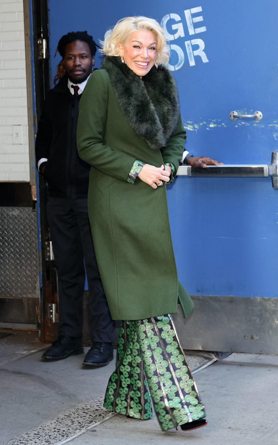 Hannah Waddingham wrapping up in a fur-trimmed green coat