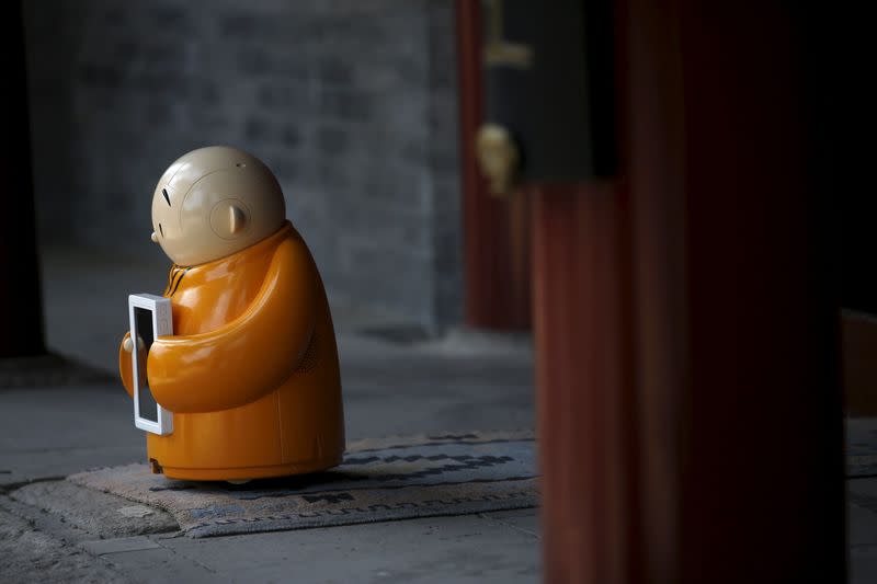 Robot Xian'er is placed in the main building of Longquan Buddhist temple for photographs by the temple's staff, on the outskirts of Beijing, April 20, 2016. REUTERS/Kim Kyung-Hoon