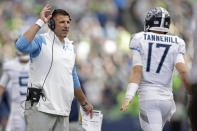 Tennessee Titans head coach Mike Vrabel, left, talks with quarterback Ryan Tannehill during the second half of an NFL football game against the Seattle Seahawks, Sunday, Sept. 19, 2021, in Seattle. The Titans won 33-30 in overtime. (AP Photo/John Froschauer)