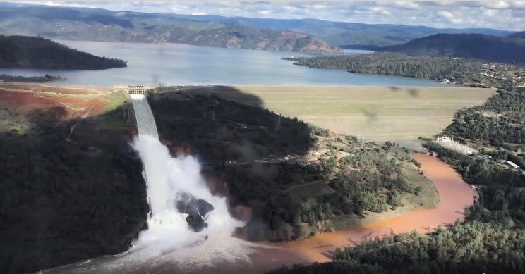 This February 2017 image from video provided by the office of Assemblyman Brian Dahle shows water flowing over an emergency spillway of the Oroville Dam in Oroville, Calif., (Josh F.W. Cook/Office of Assemblyman Brian Dahle via AP)