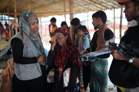Jamila Khatu, a Rohingya refugee, breaks into tears as her son in Malaysia has been traceless for eight years, at designated point of Bangladesh Red Crescent Society, at Kutupalong camp in Cox's Bazar, Bangladesh, July 4, 2018. Picture taken July 4, 2018. REUTERS/Mohammad Ponir Hossain