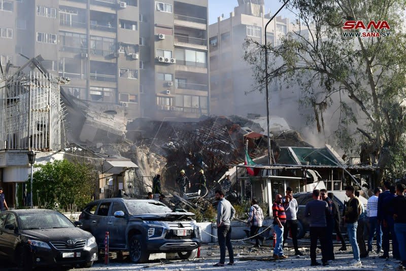 Emergency and security personnel inspect the rubble at the site of strikes which hit a building annexed to the Iranian embassy in Syria's capital Damascus on April 1. Iran on Saturday launched over 100 drones at Israel in retaliation for the attack according to Israel Defense Forces. Photo by Syrian Arab News Agency/ UPI