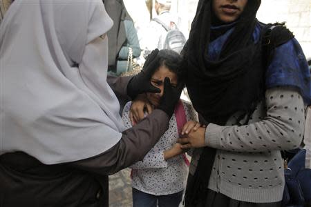 A Palestinian girl reacts after her mother was involved in scuffles with Israeli policemen as the police prevented people from entering the compound which houses al-Aqsa mosque and is known to Muslims as Noble Sanctuary and to Jews as Temple Mount, in Jerusalem's Old City April 16, 2014. REUTERS/Ammar Awad