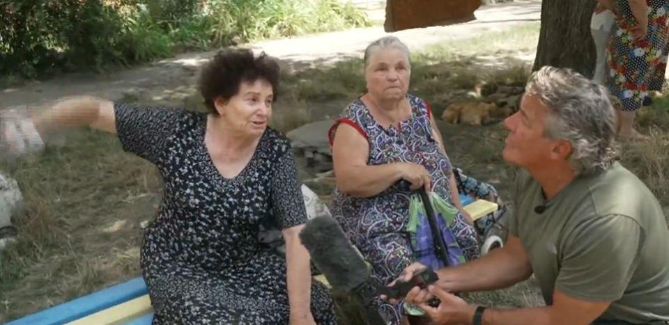 Women speak to CBS News senior foreign correspondent Charlie D'Agata outside their heavily-damaged apartment building in Marhenets, Ukraine, several days after it was struck by Russian artillery. / Credit: CBS News