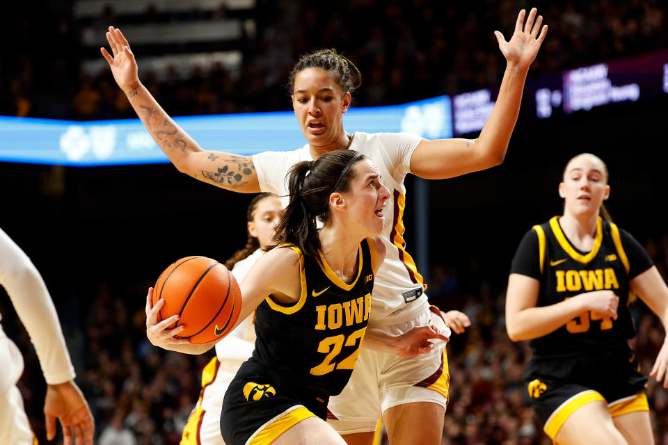 MINNEAPOLIS, MINNESOTA - FEBRUARY 28: Caitlin Clark #22 of the Iowa Hawkeyes drives to the basket against Ayianna Johnson #1 of the Minnesota Golden Gophers in the third quarter at Williams Arena on February 28, 2024 in Minneapolis, Minnesota. The Hawkeyes defeated the Golden Gophers 108-60. (Photo by David Berding/Getty Images)