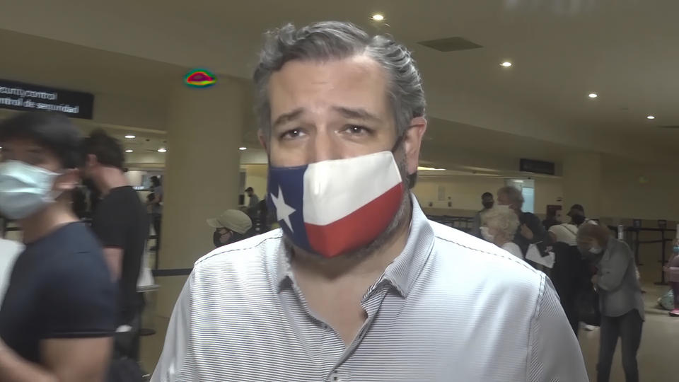 In this image from video, Sen. Ted Cruz, R-Texas, walks to check in for his flight back to the U.S., at Cancun International Airport in Cancun, Mexico, Thursday, Feb. 18, 2021. (AP Photo/Dan Christian Rojas)