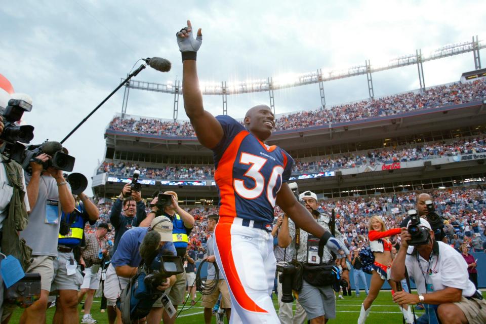 Broncos running back Terrell Davis waves to fans as he is introduced for the team's exhibition game against the San Francisco 49ers, Aug. 19, 2002, in Denver.