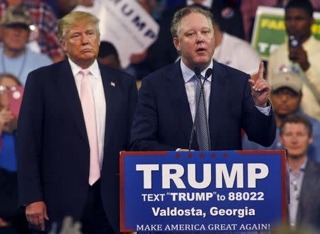 FILE PHOTO: Donald Trump listens as NASCAR CEO Brian France speaks at a campaign rally at Valdosta State University in Valdosta, Georgia February 29, 2016. REUTERS/ Philip Sears