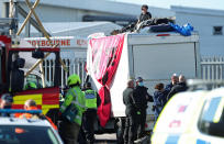 Police and fire service personnel gather around a pair of protesters on top of a van used to block the road outside the Newsprinters printing works at Broxbourne, Hertfordshire. (Photo by Yui Mok/PA Images via Getty Images)