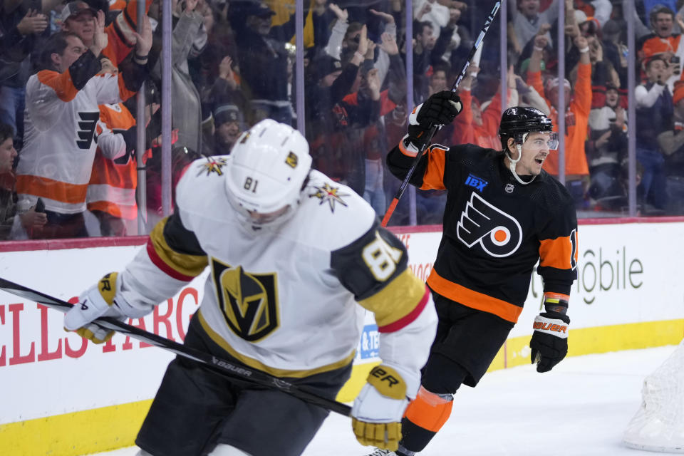Philadelphia Flyers' Travis Konecny, right, reacts past Vegas Golden Knights' Jonathan Marchessault after the Flyers' won an overtime NHL hockey game, Saturday, Nov. 18, 2023, in Philadelphia. (AP Photo/Matt Slocum)