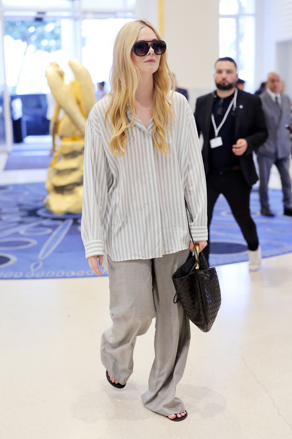 <p>Elle Fanning perfected off-duty dressing with a shirt by The Row and a Bottega Veneta bag. </p>